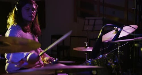 Man playing drums in a music studio