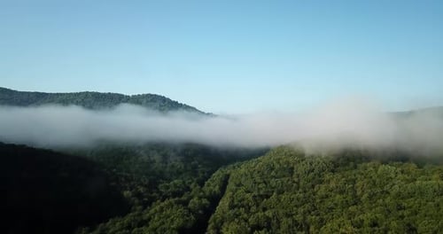 Aerial View of Fog-Shrouded Mountain Landscape
