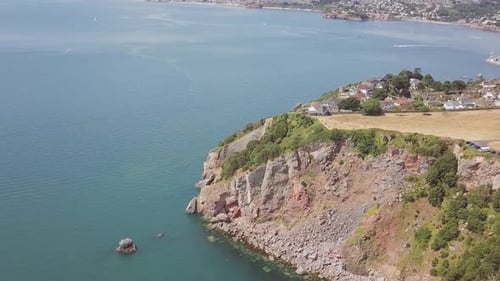 Aerial View of Rocky Coastline and Blue Ocean