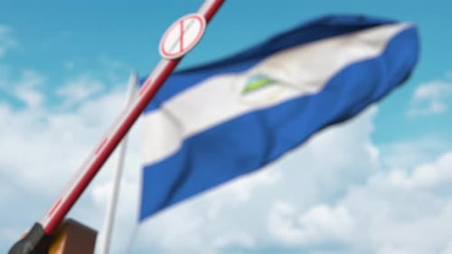 Closing Barrier with Coronavirus Sign and Nicaragua Flag
