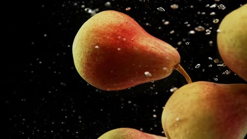 Fresh Red and Yellow Pears Fruits Falling Into Water with Splash and Air Bubbles