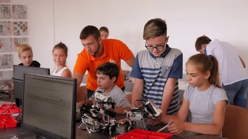 Kids Building Robot Constructor From the Plastics Details at Robotics Lesson