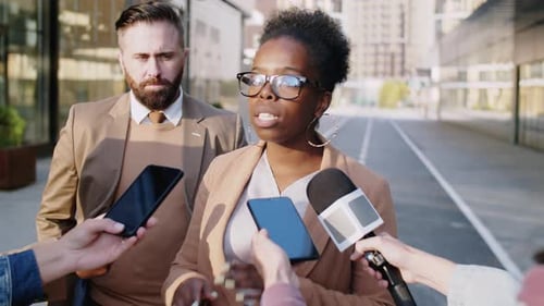 Black Woman Giving Interview to Journalists Outdoors on Street