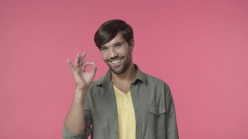 Smiling Man Giving 'Okay' Hand Gesture