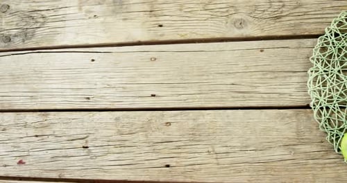 Green apples and knife on wooden plank