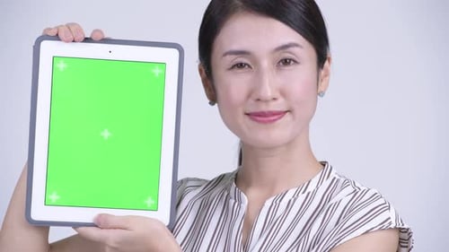 Woman Holding Tablet with Green Screen Display
