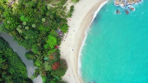 Beautiful aerial travel shot of a sandy white paradise beach and aqua blue ocean background in colou