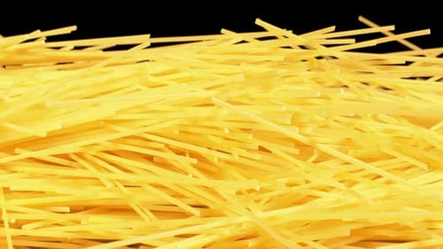 Close up of dry spaghetti against black background