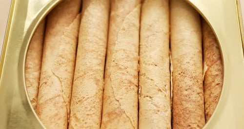 Rolled Wafer Cookies in Golden Container Close-Up