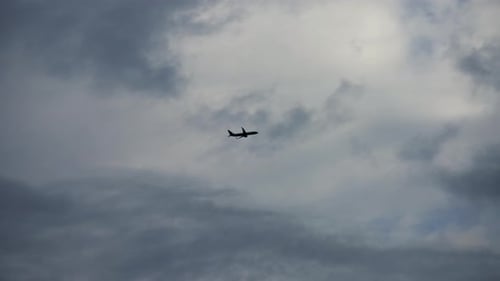 Silhouette of a plane flying in the sky
