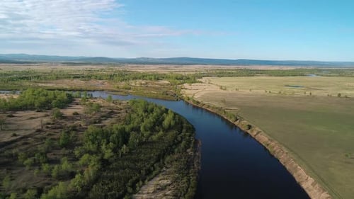 Aerial View of a River Flowing Through Rural Area with Meadows Rare Trees