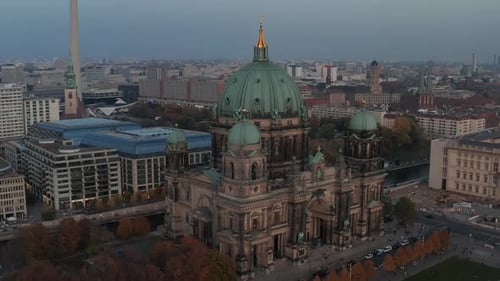 AERIAL: Circling Berlin Cathedral Beautiful Old Structure in Vibrant Fall Colors with Golden Cross