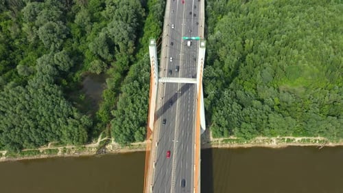 Car traffic on hanging sea bridge over bay in city view from above. Aerial View