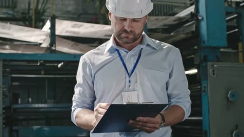 Supervisor Performing Inspection at Factory