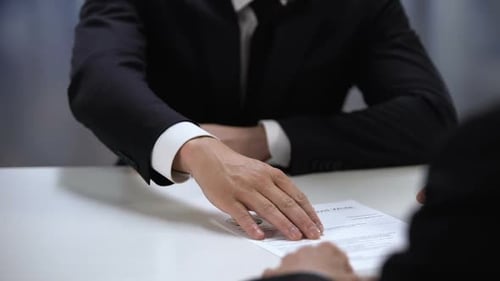 Male Candidate Presenting CV to HR Manager at Job Interview, First Impression