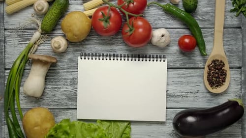 Cooking Book Thrown on Table with Recipe Ingredients