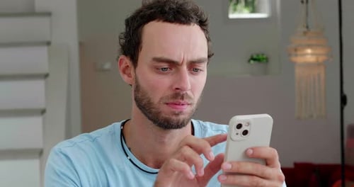 Man Using Mobile Phone at Home