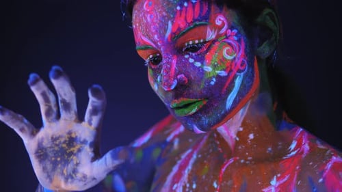 Closeup of a Girl's Face with an Ultraviolet Pattern in Neon Light
