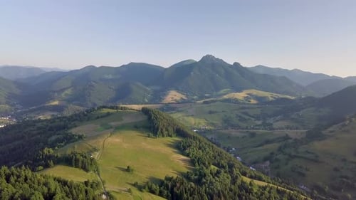 Fly Above Green Countryside Landscape in Alpine Mountains Summer
