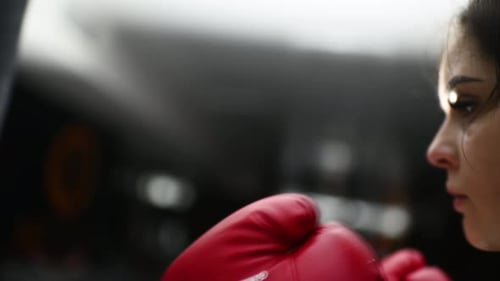 Woman with Boxing Gloves Inside Gym