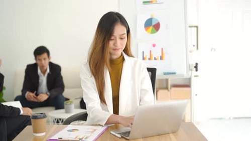Businesswoman Working on Laptop in Modern Office
