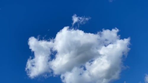 White Clouds Drifting Across a Vibrant Blue Sky