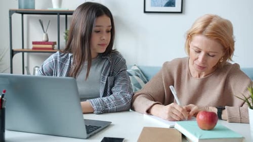 Girl and Woman Studying with Laptop at Home