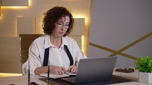 Professional Woman Using Laptop in an Office Setting