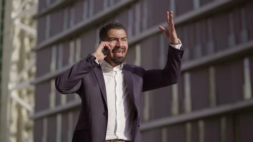Man in Suit Talking on Phone Outside Office Building