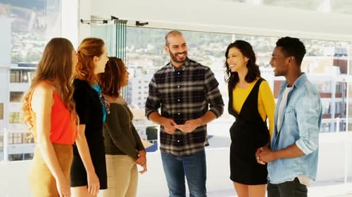Team of executives interacting with each other while working in the office