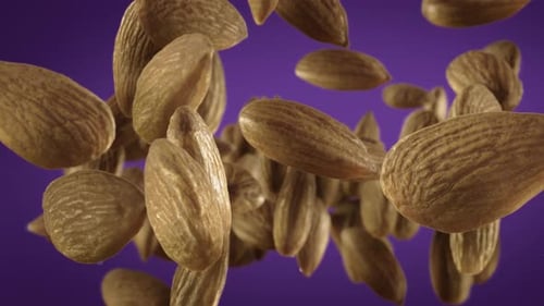 Almonds Floating Upward on Purple Background