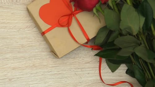 Gift Box, Roses, and Love Letter on Table