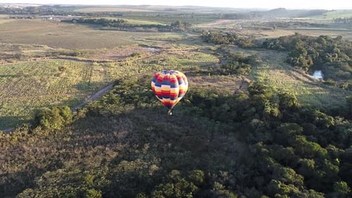 Aerial View of Hot Air Balloon over Green Landscape
