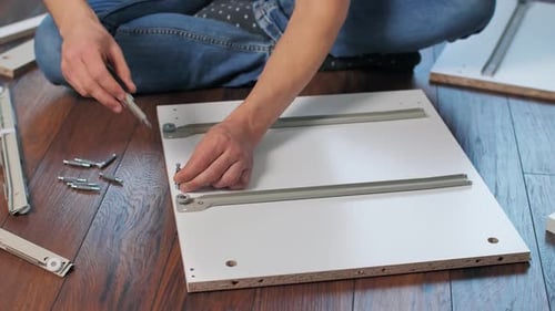 Young Adult Assembling Furniture at Home