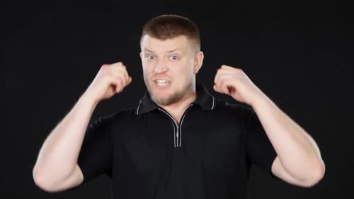 Man Speaking Angrily and Emphatically Against Black Background