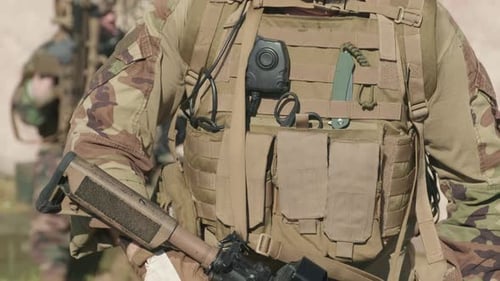 Soldier in Camouflage Uniform Holding Rifle