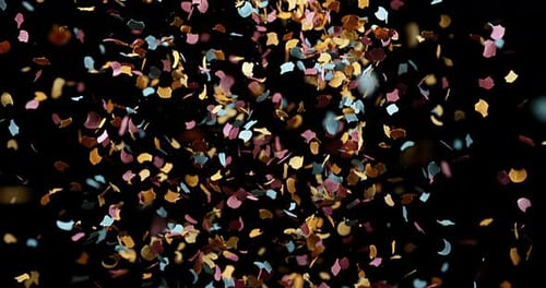 Confettis Falling against Black Background, Slow Motion 4K
