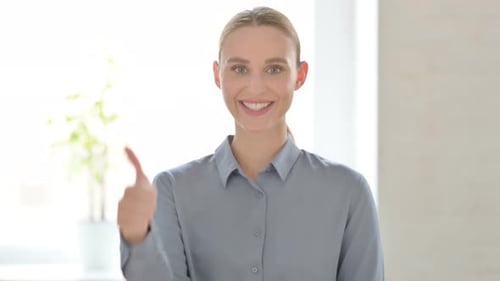 Woman Smiling and Giving Thumbs Up