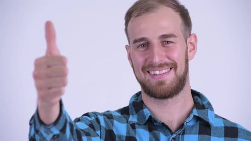 Man Smiles and Gives Thumbs Up Gesture