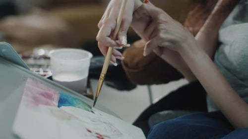Hands Painting Watercolor Art with Brush Indoors