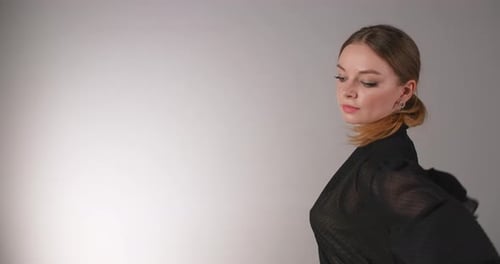 Woman Posing Elegantly in Studio Fashion Shoot