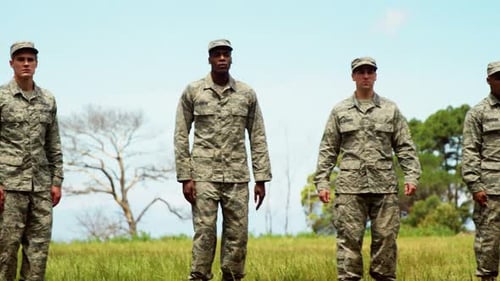 Soldiers Standing at Attention in Green Field