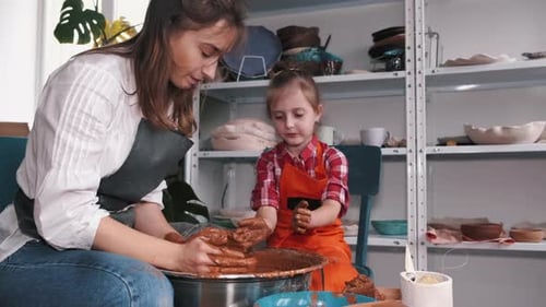 Woman and Child Creating Pottery Together