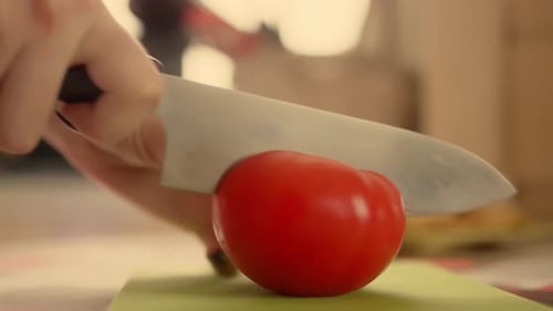 Tomato Slicing in Kitchen with Sharp Knife