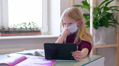 Young Girl Studies Using Tablet at Home
