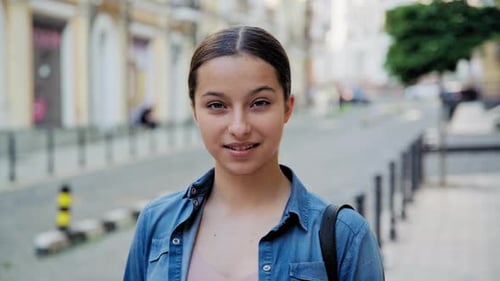 Young Woman Smiling in City Street