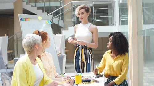 Group of Young Designers Collaborating on Project in Office