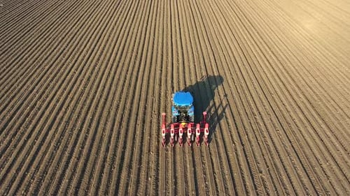 Tractor Planting Crops in a Rural Field