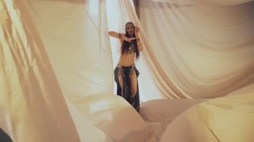 Elegant Woman Belly Dancing in White Tent