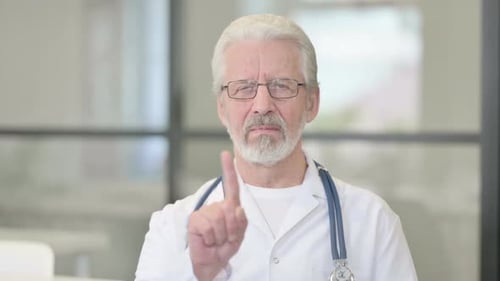 Mature Doctor Rejects with Finger Gesture